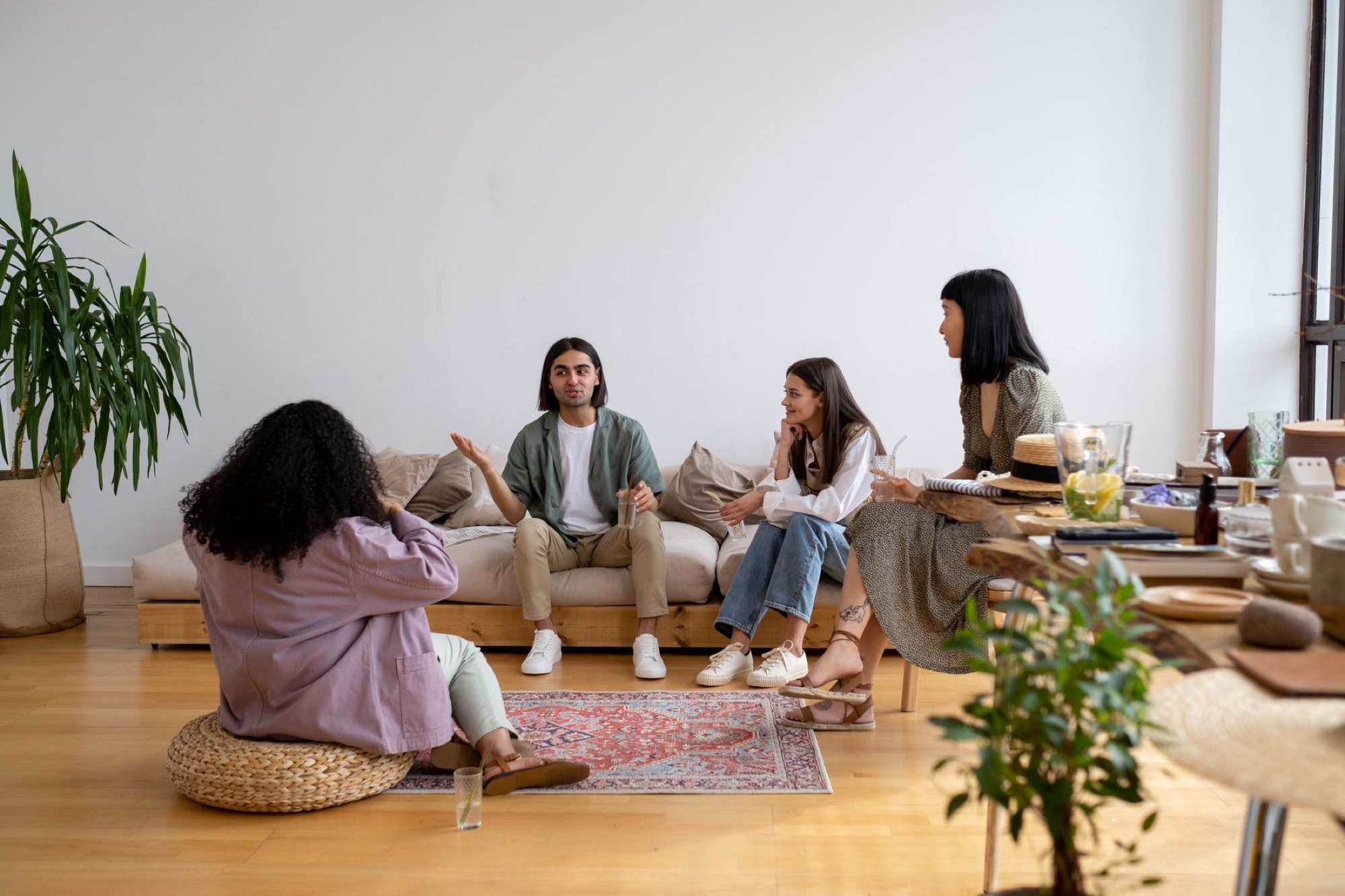 Friends sitting together in a living room, talking